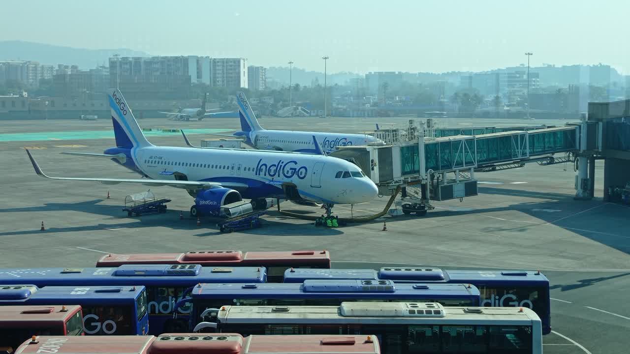 An IndiGo aircraft at an airport gate