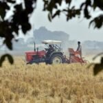 A tractor working in a stubble field — symbolic photo